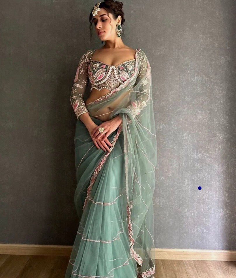 Latest Bollywood Style Pastel Green Embroidered Blouse with Pearl Detailing and Premium
Net Saree