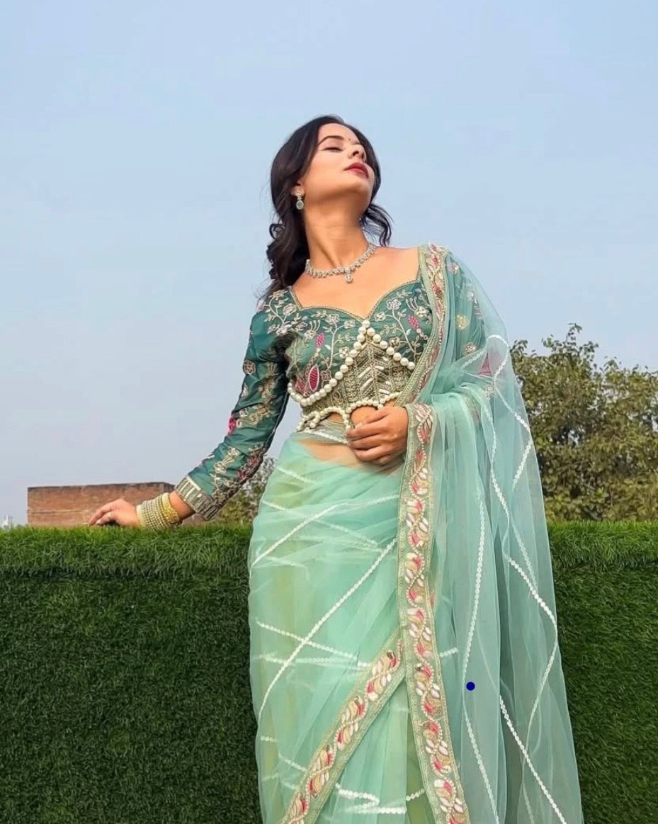 Latest Bollywood Style Pastel Green Embroidered Blouse with Pearl Detailing and Premium
Net Saree